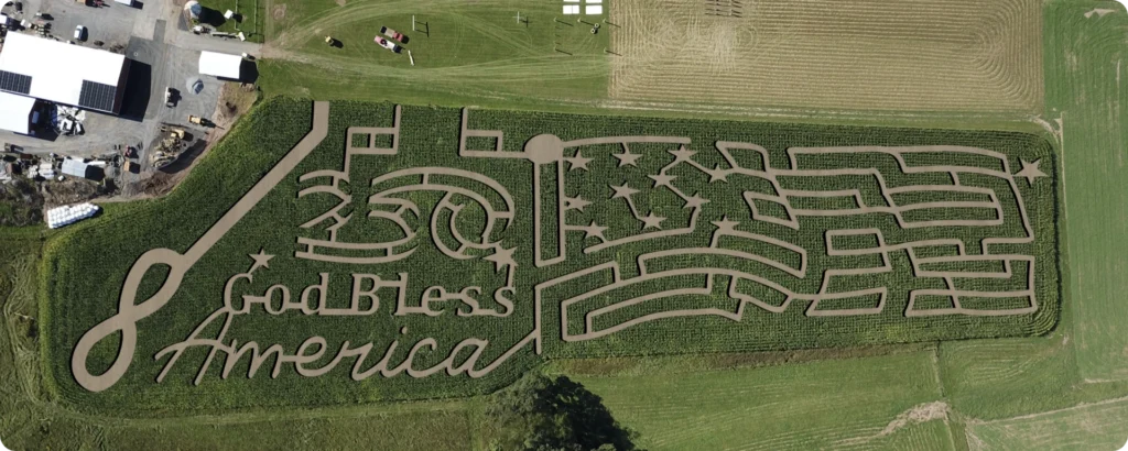 Aerial view of patriotic corn maze reading “God Bless America” in a green field