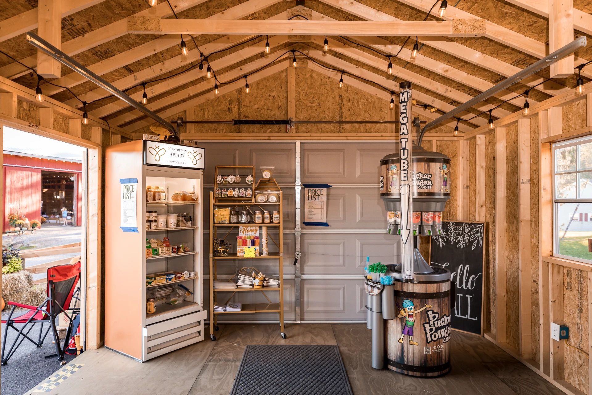 Rustic wooden farm stand interior with shelves, drinks cooler, and handcrafted country charm.